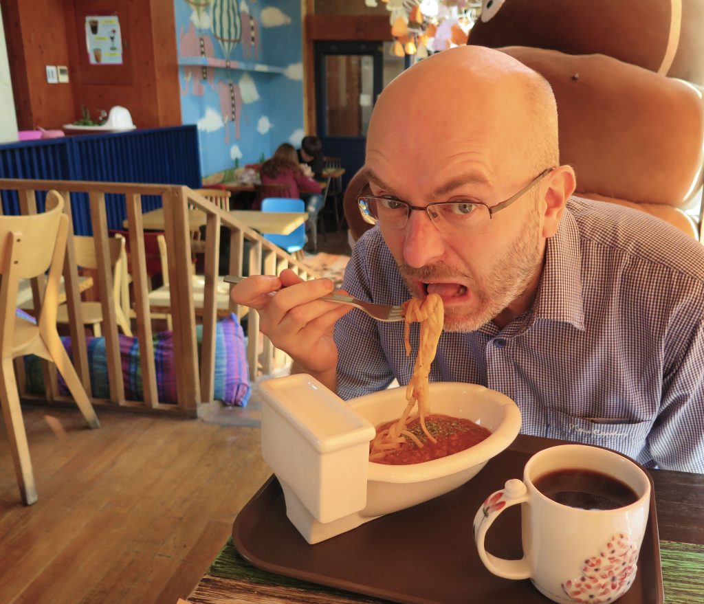 Me eating at the Poop Cafe (Ddong Cafe) in Seoul, South Korea.