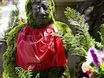 A statue covered in moss at the Hozenji Temple in Osaka, Japan.