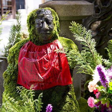 A statue covered in moss at the Hozenji Temple in Osaka, Japan.