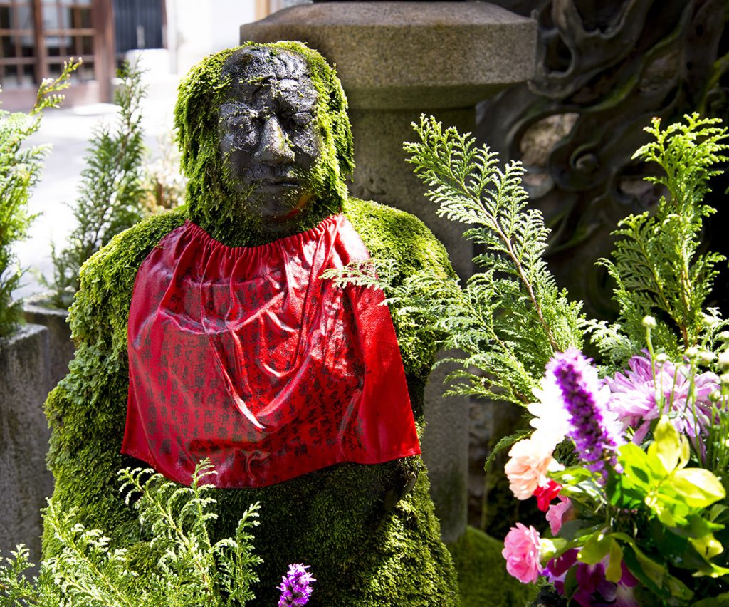 A statue covered in moss at the Hozenji Temple in Osaka, Japan.